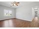 Bright bedroom featuring hardwood floors, a ceiling fan, and a large window at 4010 Arborwood Ln, Tucker, GA 30084