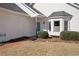 The home's exterior showcases a well-manicured lawn, brick walkway, and bright bay window at 4010 Arborwood Ln, Tucker, GA 30084