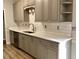 Modern kitchen with gray cabinets, stainless appliances, and bright quartz countertops at 4010 Arborwood Ln, Tucker, GA 30084