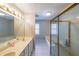 Well-lit bathroom featuring double sinks, a tub, and a glass-enclosed shower area at 50 Sycamore Sta, Decatur, GA 30030