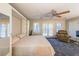 Inviting bedroom with ample natural light, a ceiling fan, and relaxed seating area at 50 Sycamore Sta, Decatur, GA 30030