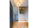 Entry foyer featuring hardwood floors, staircase with white risers, and a partially opened front door at 50 Sycamore Sta, Decatur, GA 30030