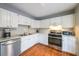 Well-lit kitchen boasts stainless appliances, marbled countertops, and white cabinetry at 50 Sycamore Sta, Decatur, GA 30030