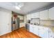 Eat-in kitchen has stainless steel refrigerator, granite countertops, and ample storage at 50 Sycamore Sta, Decatur, GA 30030