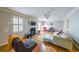 Cozy living room featuring hardwood floors, fireplace, a ceiling fan, and abundant natural light at 50 Sycamore Sta, Decatur, GA 30030