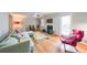 Cozy living room featuring hardwood floors, fireplace, a ceiling fan, and abundant natural light at 50 Sycamore Sta, Decatur, GA 30030