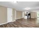 Open-concept living space connecting the living area and kitchen with modern floors and a fresh, neutral palette at 5125 West St, Forest Park, GA 30297