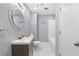 Bathroom featuring modern sink, stylish mirror, and white tiled tub at 712 Berts Nw Cir, Lilburn, GA 30047