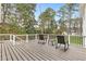 Outdoor deck with rocking chairs overlooking the treed backyard at 712 Berts Nw Cir, Lilburn, GA 30047