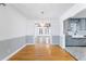 Dining room leading into the kitchen with hardwood floors and contemporary lighting at 712 Berts Nw Cir, Lilburn, GA 30047