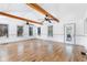 Inviting living room with exposed wood beams, updated flooring, and natural light at 712 Berts Nw Cir, Lilburn, GA 30047