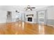 Open living room with hardwood floors, fireplace, and staircase to the upper level at 712 Berts Nw Cir, Lilburn, GA 30047