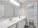 Bathroom with double sink vanity, large mirror and modern lighting at 980 Charter Club Dr, Lawrenceville, GA 30043