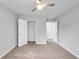 Bedroom with carpeting features a ceiling fan, closet and doorway at 980 Charter Club Dr, Lawrenceville, GA 30043