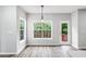 Eating area with multiple windows, a door to a deck, and contemporary pendant lighting at 980 Charter Club Dr, Lawrenceville, GA 30043