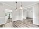 Bright dining room with stylish light fixtures and open access to the kitchen, showcasing modern design at 980 Charter Club Dr, Lawrenceville, GA 30043