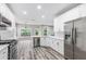 Modern kitchen featuring stainless steel appliances, white cabinetry, and ample counter space for cooking at 980 Charter Club Dr, Lawrenceville, GA 30043