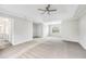 Spacious main bedroom with tray ceiling, ceiling fan, plush carpet, and natural light from the large window at 980 Charter Club Dr, Lawrenceville, GA 30043