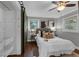 Bedroom with a ceiling fan, barn door, and a large window allowing natural light at 1464 Sagamore Ne Dr, Atlanta, GA 30345