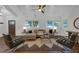 Bright living room with hardwood floors, a ceiling fan, white trim, and abundant natural light at 1464 Sagamore Ne Dr, Atlanta, GA 30345