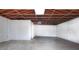 An unfinished basement space with exposed ceiling beams and concrete floors at 4585 Yates Rd, Atlanta, GA 30337
