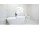 Elegant bathroom featuring a standalone tub with matte black hardware and pristine marble tiling at 4585 Yates Rd, Atlanta, GA 30337