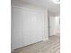 Bedroom with modern closet, light vinyl flooring, and doorway leading to additional rooms at 4585 Yates Rd, Atlanta, GA 30337