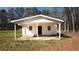 A small, free-standing outbuilding with a covered patio and white painted brick at 4585 Yates Rd, Atlanta, GA 30337
