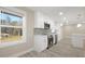 Modern kitchen with white cabinetry, stainless steel appliances, and lots of natural light at 4585 Yates Rd, Atlanta, GA 30337