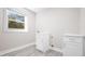 Functional laundry room features cabinetry, laminate floors, and a window at 4585 Yates Rd, Atlanta, GA 30337