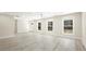 A spacious, well-lit living room features large windows and modern ceiling fan at 4585 Yates Rd, Atlanta, GA 30337
