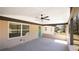 Covered porch with ceiling fan, cream brick wall, and a green entry door at 4585 Yates Rd, Atlanta, GA 30337