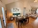 Inviting living room with a dining table, sofa, and natural light streaming through the doorway at 4835 John Burruss Rd, Cumming, GA 30040