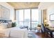 Bedroom featuring city view with large window, desk area and hardwood floors at 855 Peachtree Ne St # 3110, Atlanta, GA 30308