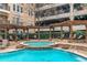 Community pool and hot tub beneath trellised patio cover, surrounded by hedges at 1850 Cotillion Dr # 4419, Atlanta, GA 30338