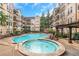 Community pool and hot tub, surrounded by condos and verdant landscaping at 1850 Cotillion Dr # 4419, Atlanta, GA 30338