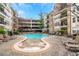 Community pool with lounge chairs, surrounded by multi-story condos and a covered parking deck at 1850 Cotillion Dr # 4419, Atlanta, GA 30338