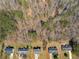 An overhead view of the wooded community highlights a row of well-maintained homes with lush lawns at 195 Brighton Dr, Covington, GA 30016