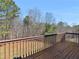 This backyard deck features wooden floors, a sturdy railing and overlooks a natural, wooded landscape at 195 Brighton Dr, Covington, GA 30016