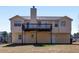 Rear exterior view of the home featuring a large deck and access to the backyard at 195 Brighton Dr, Covington, GA 30016