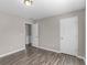 This bedroom features hardwood floors, neutral-colored walls, and a large closet at 195 Brighton Dr, Covington, GA 30016