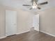 A bright bedroom features wood-look floors, a ceiling fan, and two bright white doors at 195 Brighton Dr, Covington, GA 30016