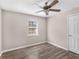 This bedroom features a window for natural lighting, hardwood floors, and neutral-colored walls at 195 Brighton Dr, Covington, GA 30016