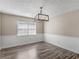 Dining room with window, modern light fixture, and chair rail at 195 Brighton Dr, Covington, GA 30016