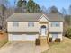 Inviting two-story home featuring a 2-car garage, new roof, and charming front entrance with new wood steps at 195 Brighton Dr, Covington, GA 30016