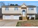 Inviting two-story home featuring a 2-car garage, new roof, and charming front entrance with new wood steps at 195 Brighton Dr, Covington, GA 30016