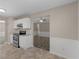 Cozy kitchen featuring white cabinets and stainless steel appliances open to the living room at 195 Brighton Dr, Covington, GA 30016