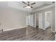 Lovely main bedroom with hardwood flooring, ceiling fan, and access to the ensuite bath and walk-in closet at 195 Brighton Dr, Covington, GA 30016