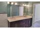 Bathroom with double vanity, modern fixtures, and a large mirror with decorative lighting at 2015 Aldbury Ln, Woodstock, GA 30189