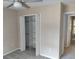 Bright bedroom features a closet with shelving and gray carpet at 2015 Aldbury Ln, Woodstock, GA 30189